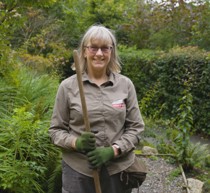 Portrait of gardener Helen Lannon holding broom