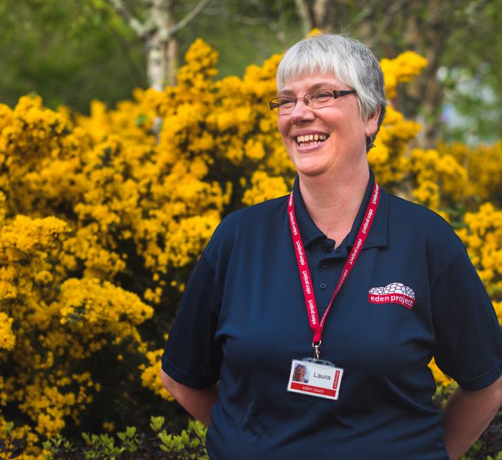 Laura Brown, Eden Project staff member, standing in front of gorse