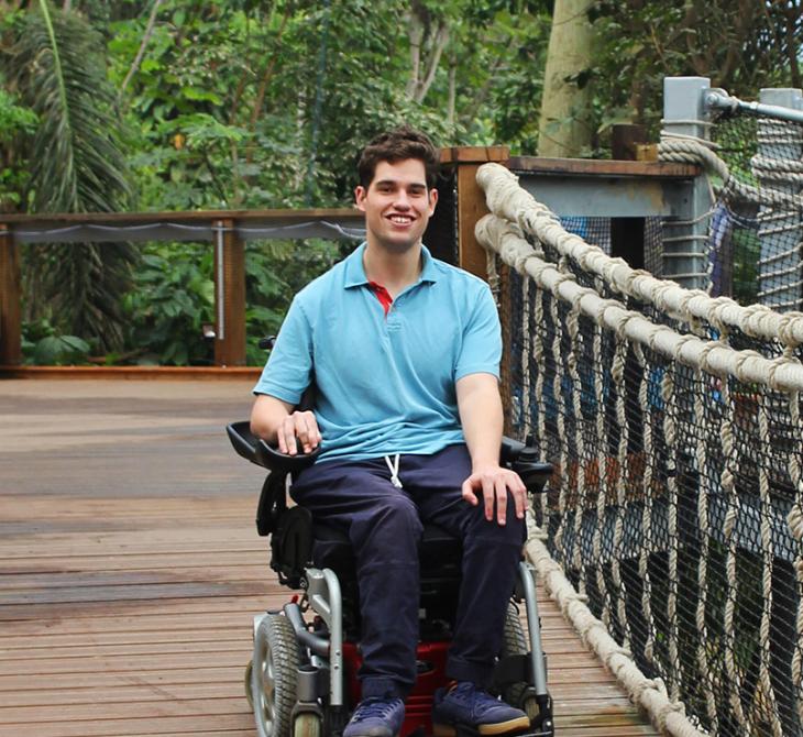Eden volunteer, Oliver Goulding, in a wheelchair in the Rainforest Biome