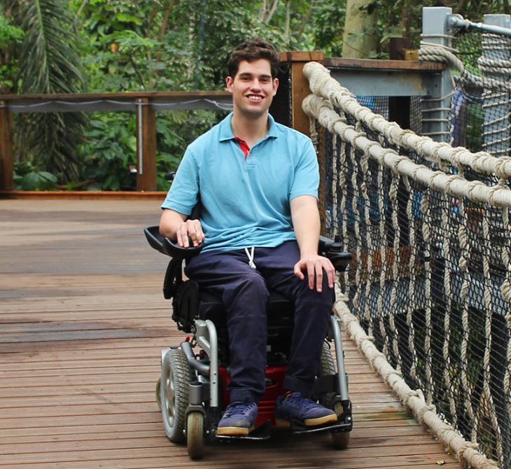 Eden volunteer, Oliver Goulding, in a wheelchair in the Rainforest Biome