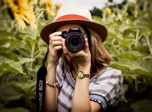 Woman holding camera up to face