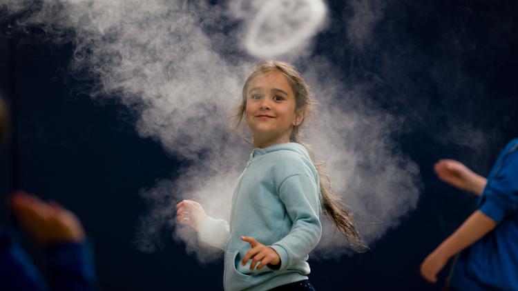 Girl looking at smoke ring from Infinity Blue sculpture