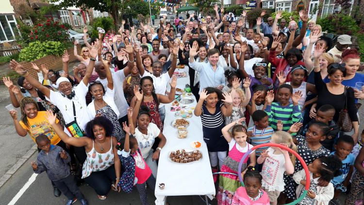 People waving at a street party 