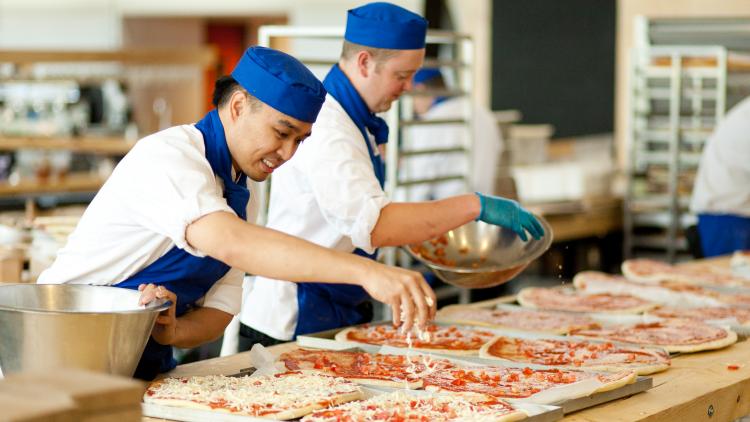 Chefs preparing pizza