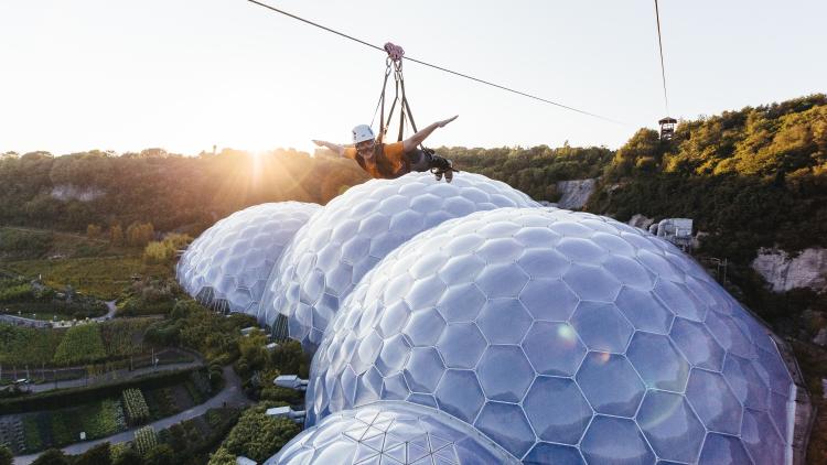 Person on zip wire over Eden Project