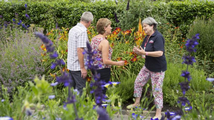 Member of Eden staff talking to the visitors