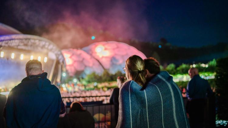 Couple wrapped in blanket watching Eden Session