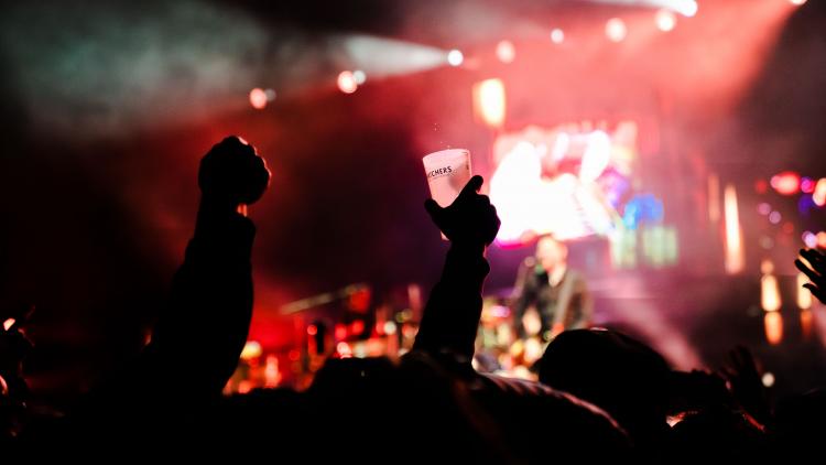 Crowd's hands in the air and holding a drink at an Eden Session