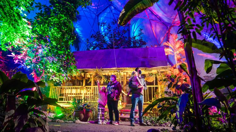 Family outside Malaysian house in Rainforest