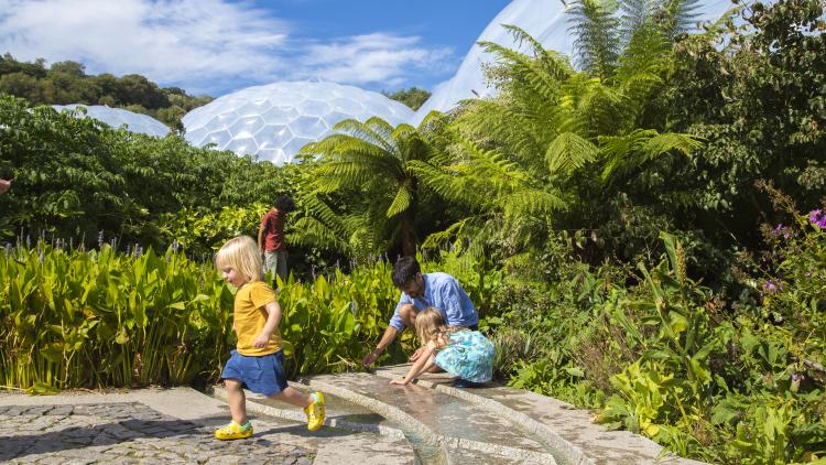 Family playing in the Outdoor Gardens on a sunny day