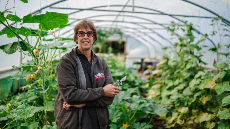 Horticultural Therapist Julia standing amongst plants in polytunnel