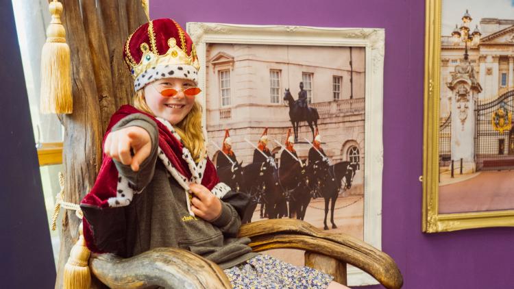 Girl dressed up as a royal posing
