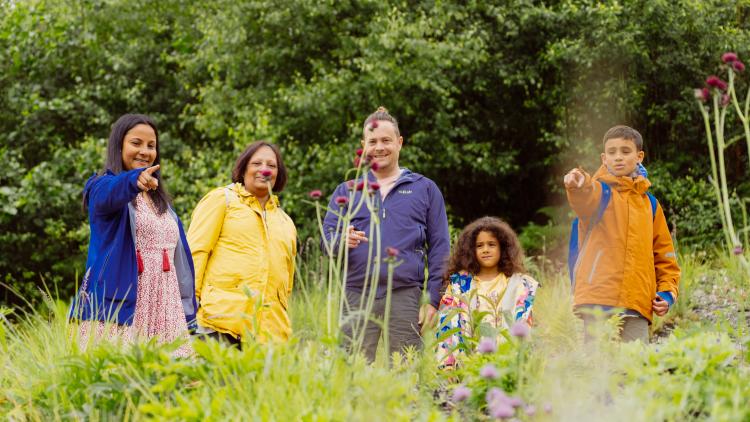 Family pointing at flowers