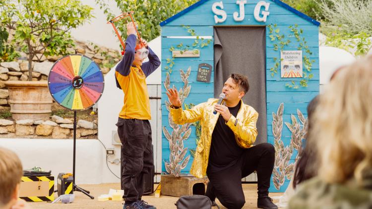 The Skinny Jean Gardener with boy taking part in a game