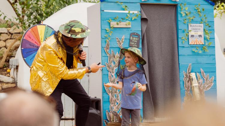 Skinny Jean Gardener with boy dressed in beekeeping hats