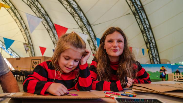 Girls in Beano striped tops making placards