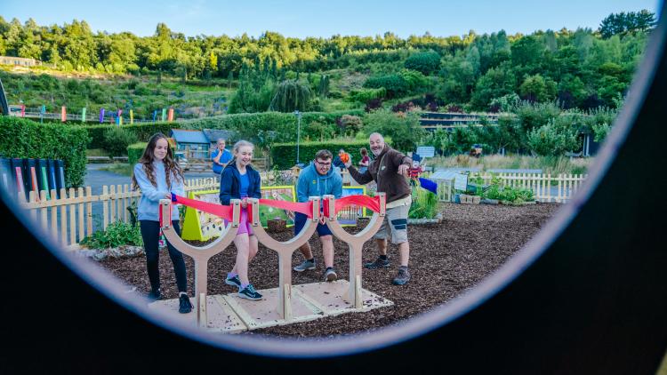 Family pulling back giant catapults