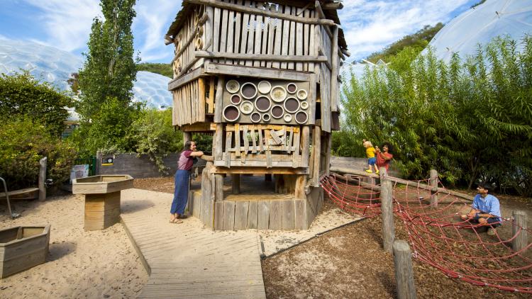 Family playing by Minibeast Mansion