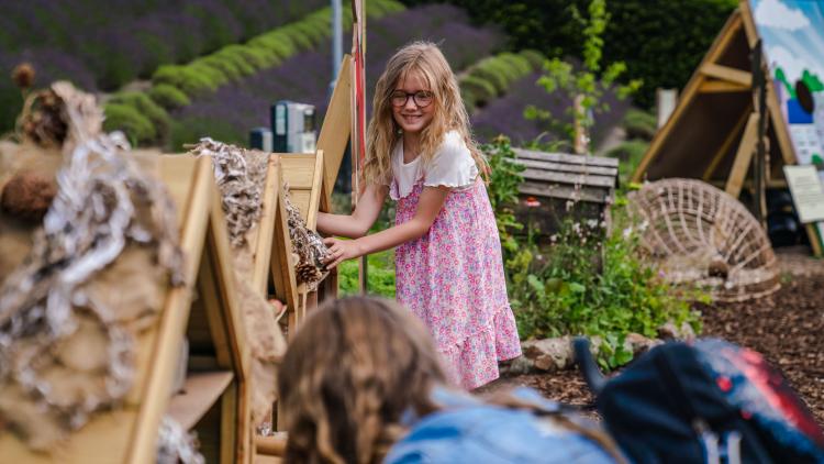 Girl playing a game building a bug hotel