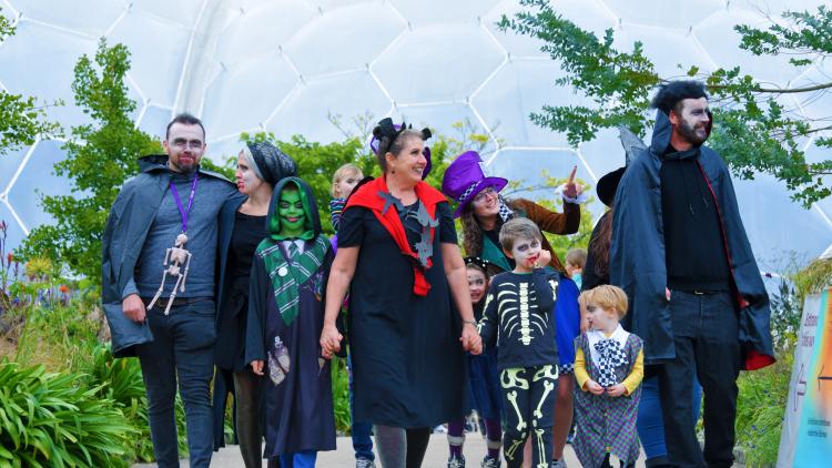 Families dressed up in Halloween costumes walking at the Eden Project