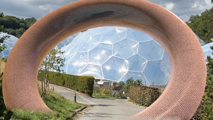 An augmented reality archway over a path at Eden with biomes in the background