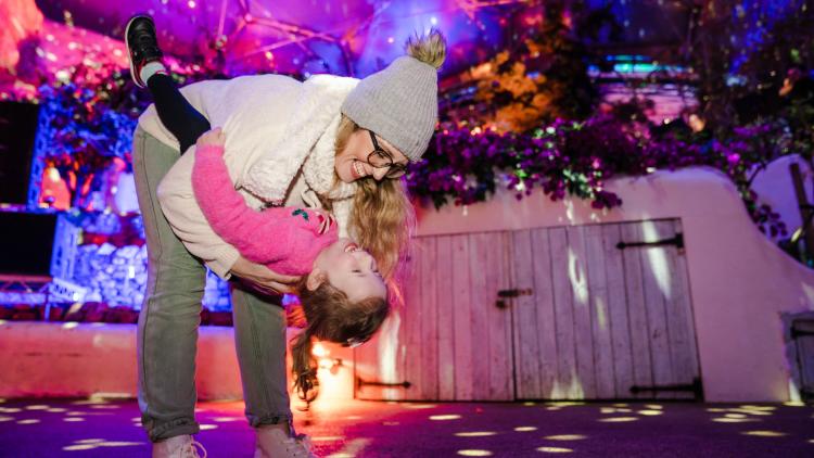 Mother and daughter dancing in the Med Biome at Christmas