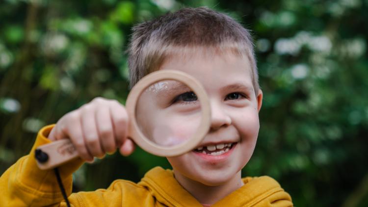Boy with magnifying glass