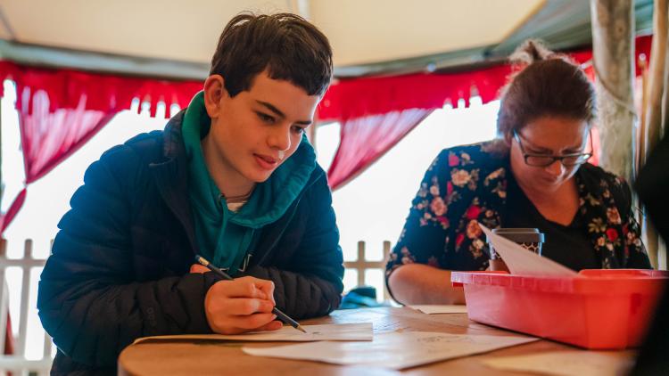 Teenage boy taking part in a Tom Gates' inspired drawing workshop