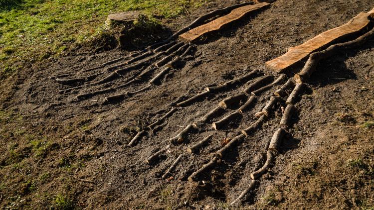 Close up of the feet of a giant stick skeleton sculpture