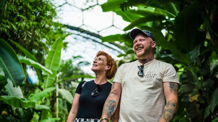 Couple holding hands and laughing in the Rainforest Biome