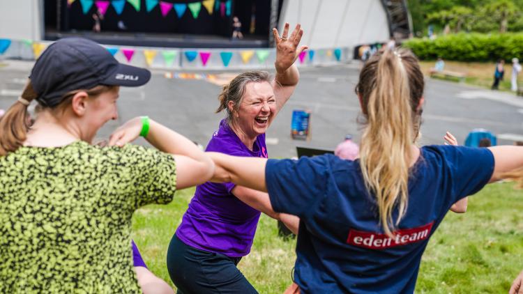 People laughing doing a dancing workshop