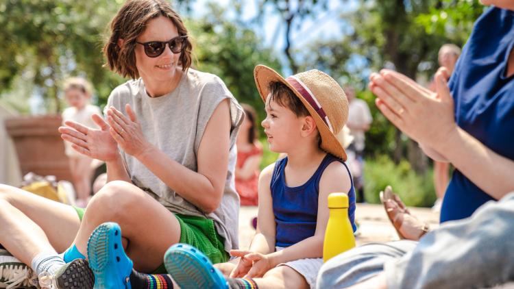 Mum and young son clapping