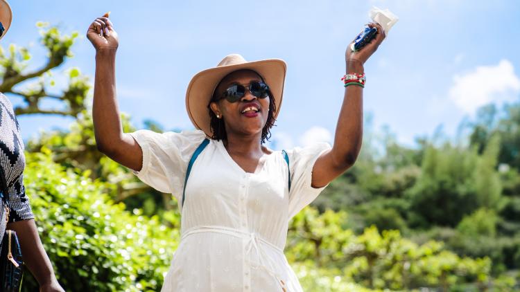 Woman in a white dress and straw hat dancing