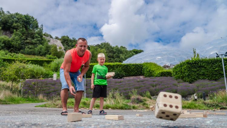 Father and son smiling and playing outdoor games 