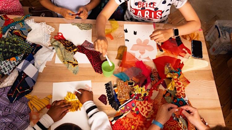 Crafts Council: Table full of crafting materials including fabric and paper