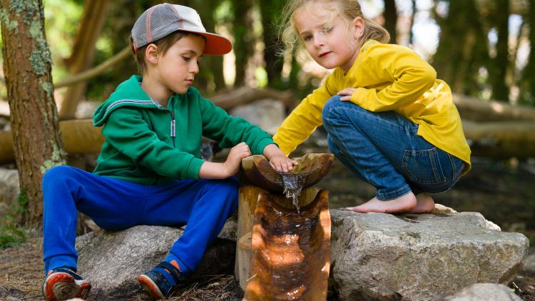 Two children playing with water