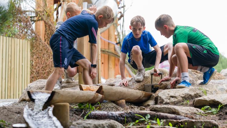 Boys playing with water streams