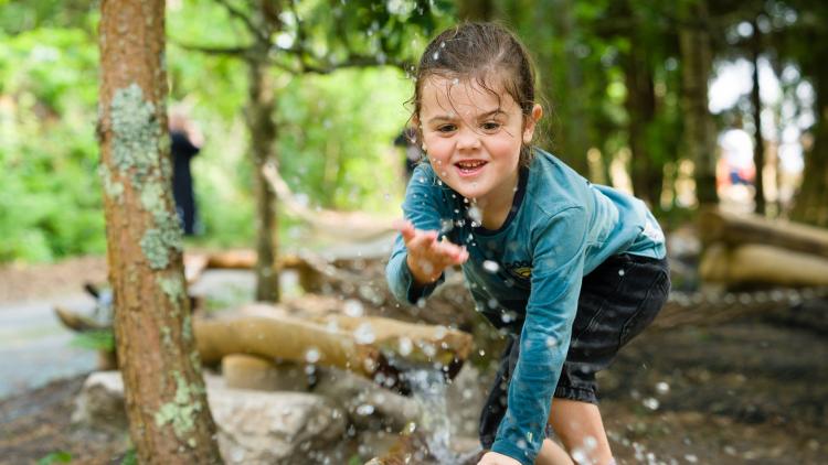 Young child splashing water