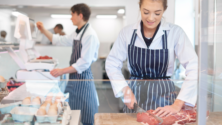 A butcher chopping meat