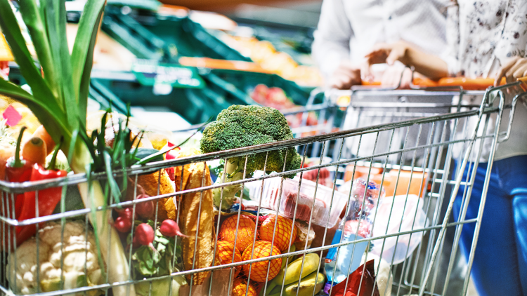 Trolley full of shopping, fruits, vegetables and packets