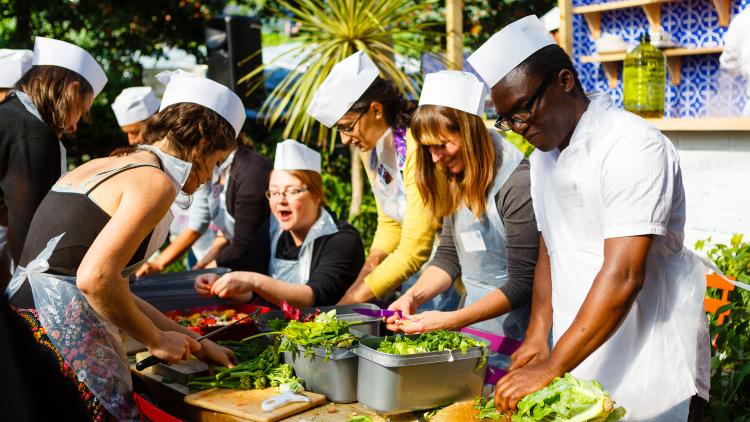 People preparing veg on an Eden Project Communities Camp