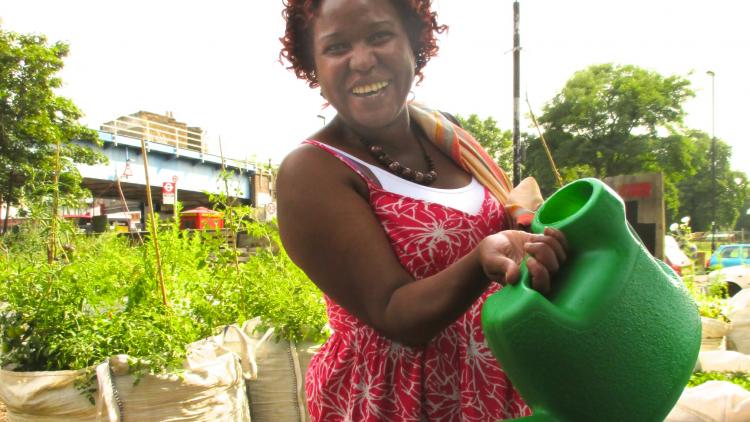 Woman in red dress with watering can