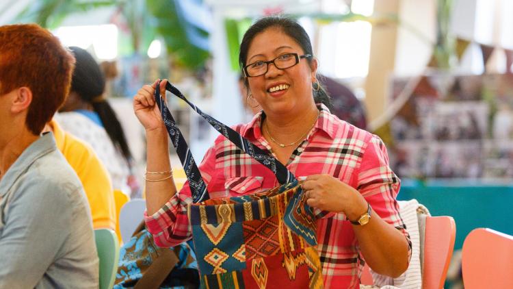 Woman holding up a fabric shopping bag