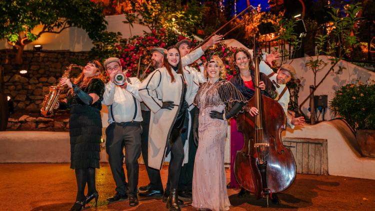 1920s band dressed up holding instruments and posing.