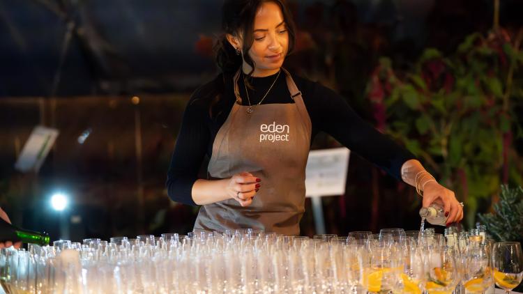 Eden staff member pouring drinks at an event