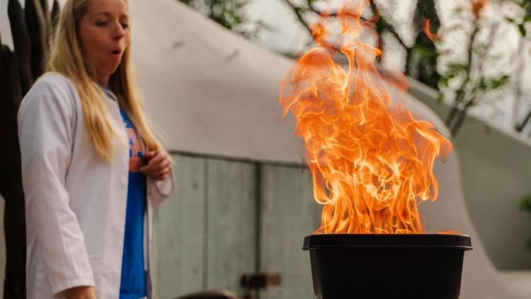 Scientist reacting to a bowl of fire in a science show at the Eden Project