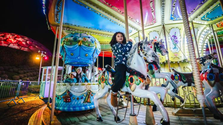 Child riding carousel at the Eden Project