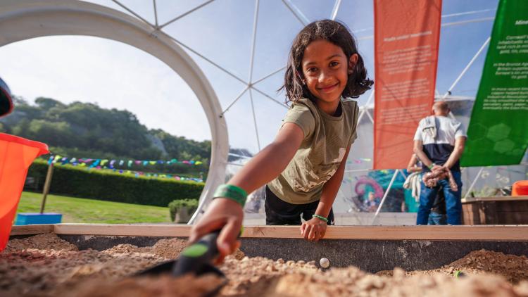 Girl digging in dig pit