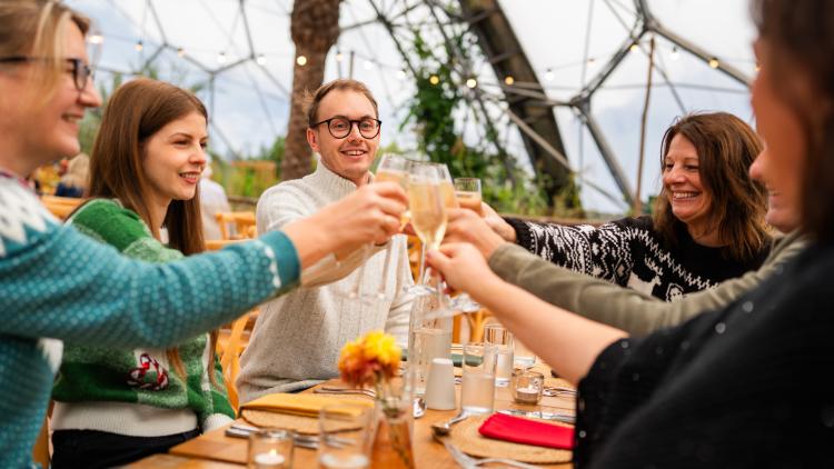Guests raising a glass of prosecco at the Mediterranean Biome Christmas Lunch