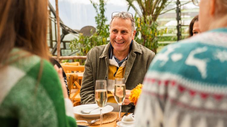 Man eating at table during Mediterranean Biome Christmas Lunch